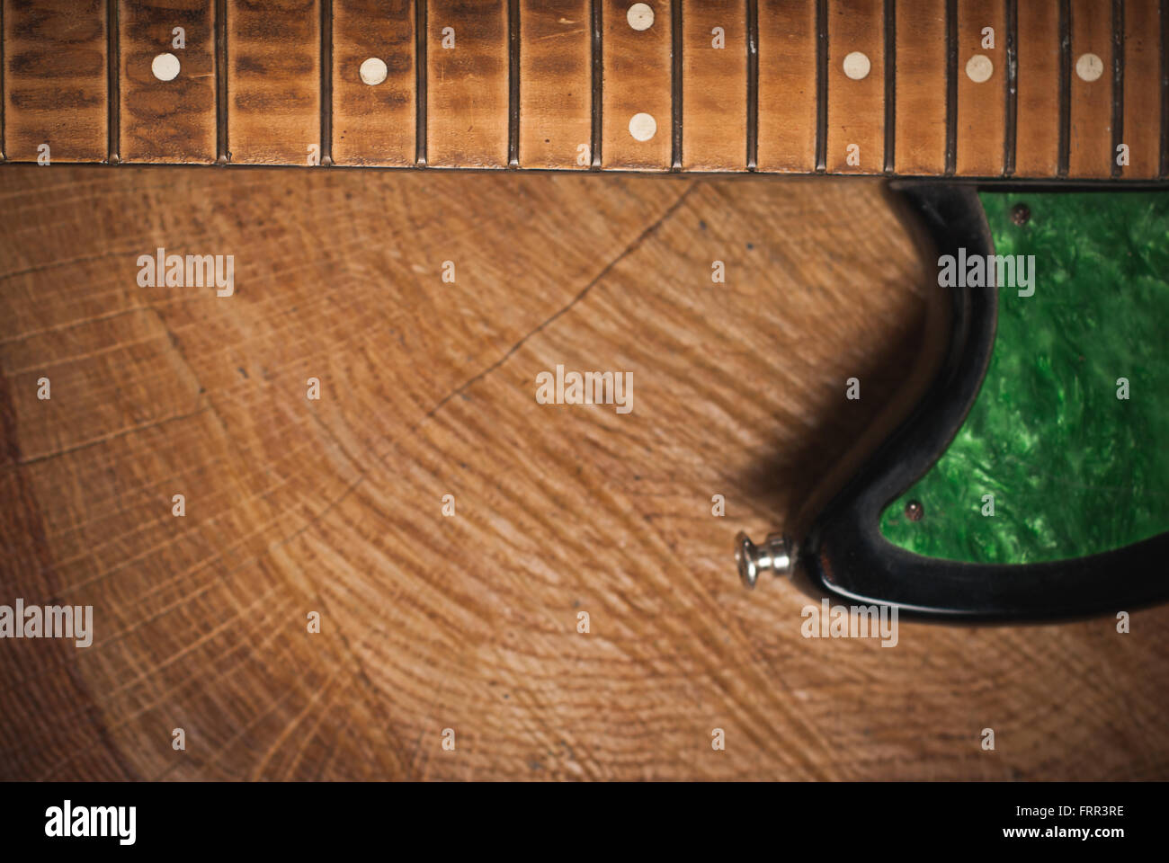 electric guitar without strings on wooden background, copy space Stock