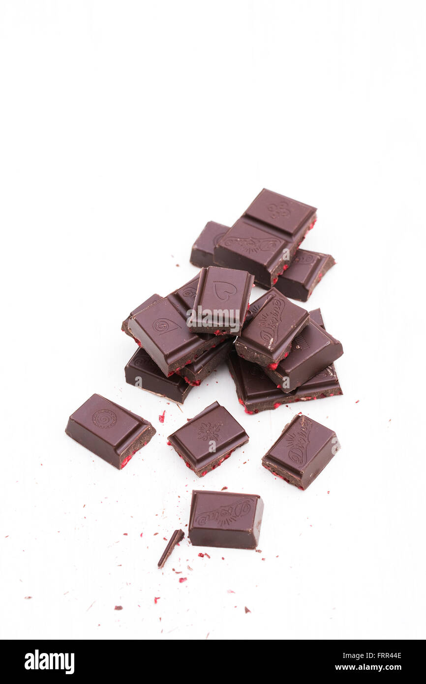 Divine chocolate pieces on a white background. Stock Photo