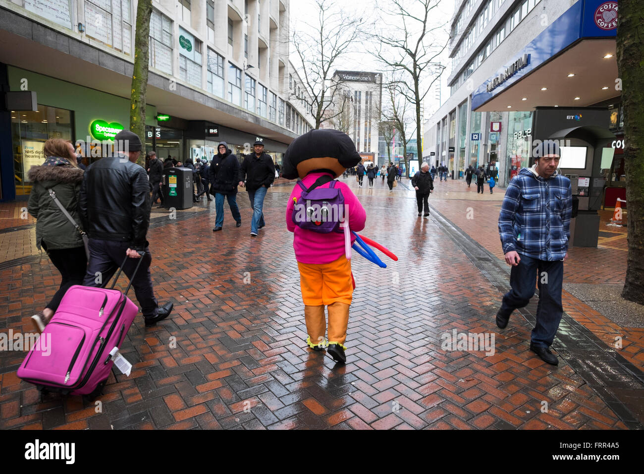 Street seller in Dora the Explorer costume selling balloons in New Street, Birmingham, West Midlands, UK Stock Photo