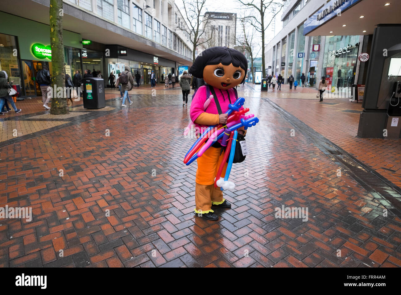 A modelling balloon seller in Dora the Explorer costume at New Street, Birmingham, West Midlands, UK Stock Photo