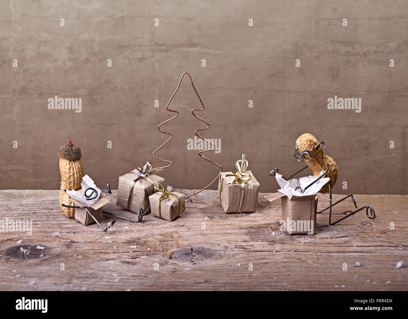 Simple Things - Miniature with Peanut People on Christmas unpacking their presents Stock Photo