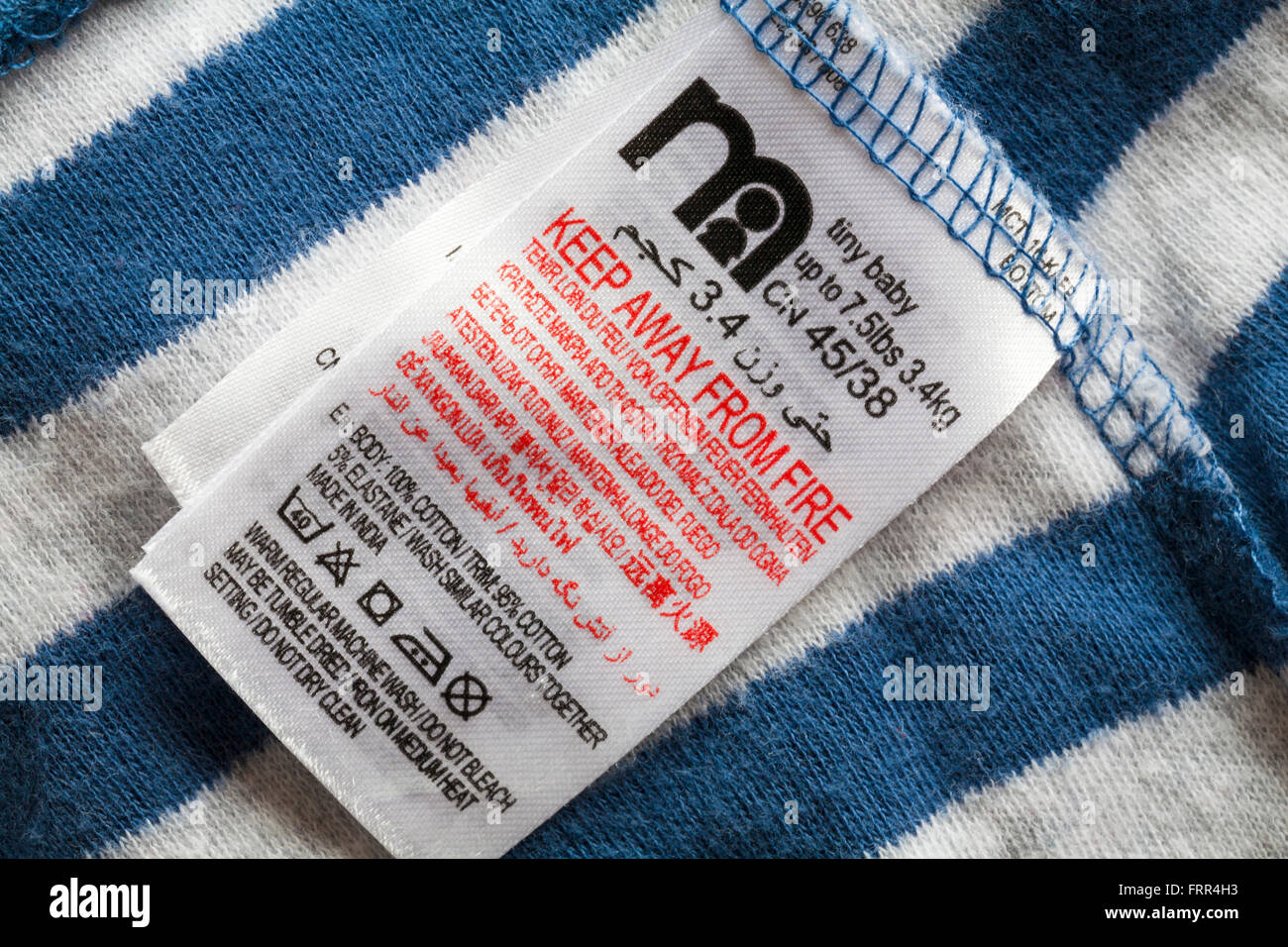 label in Mothercare tiny baby's leggings - keep away from fire made in India - sold in the UK United Kingdom, Great Britain Stock Photo