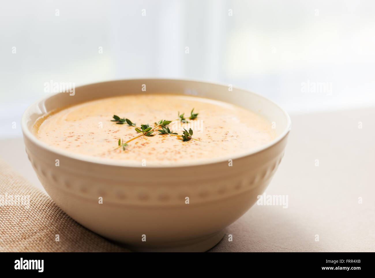 A bowl of lobster bisque soup with thyme garnish. Antique filter applied Stock Photo Alamy