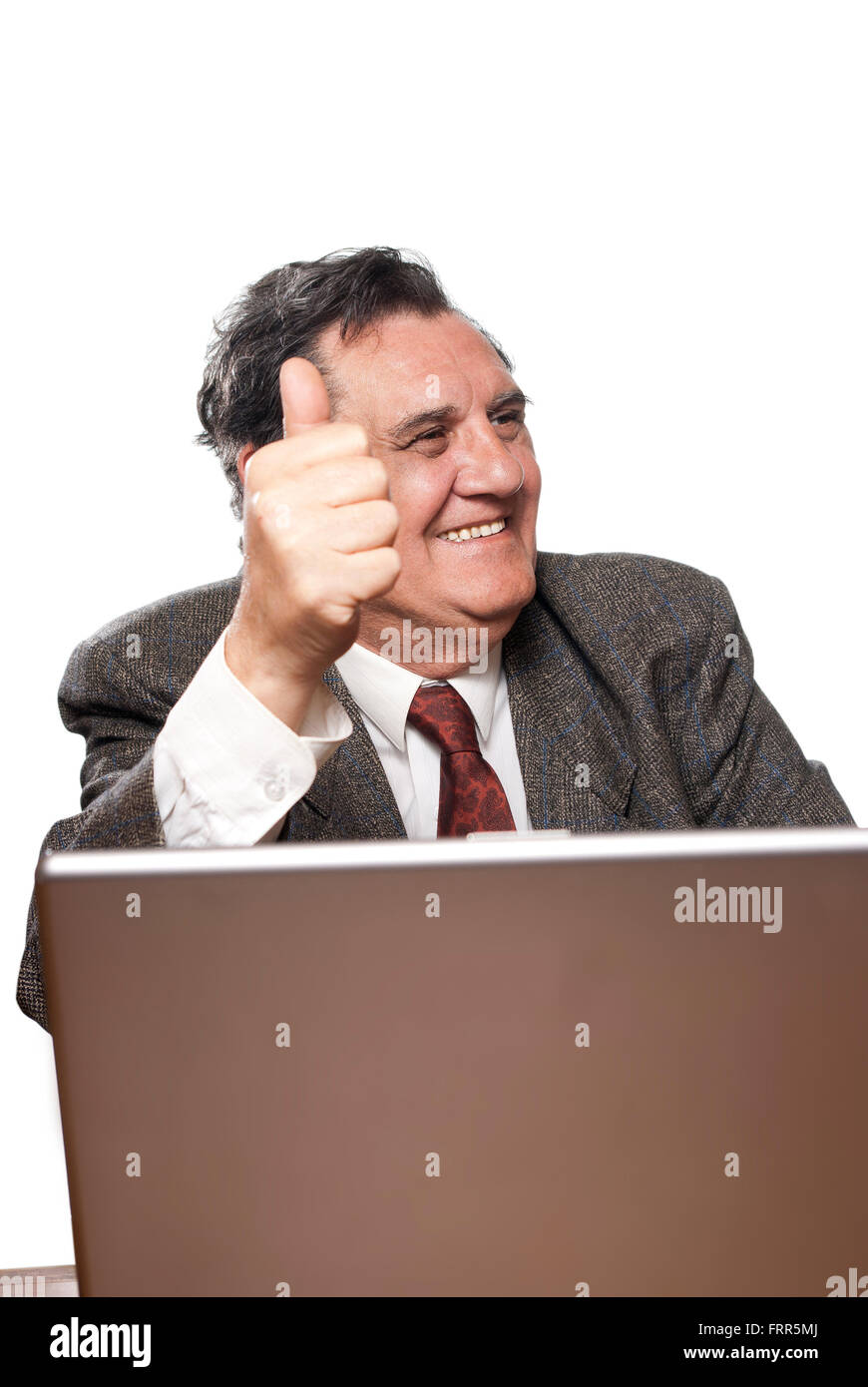 Portrait of a happy business man with a laptop isolated on white background gesturing thumbs up to someone Stock Photo