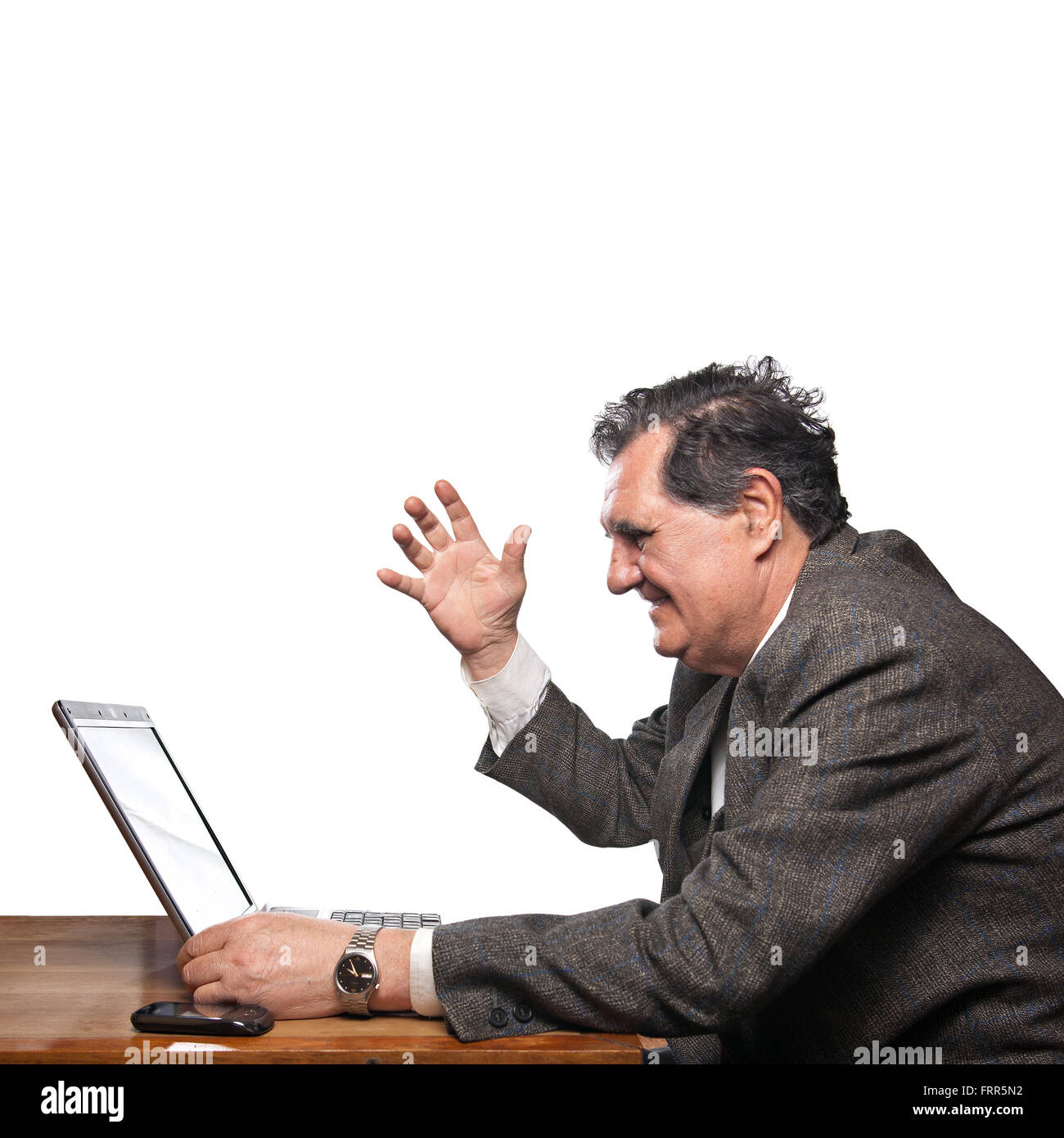 Portrait of a happy business man with a laptop isolated on white background gesturing Stock Photo