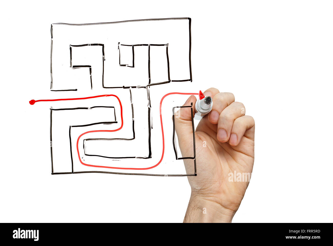Man drawing the way out through a maze Stock Photo