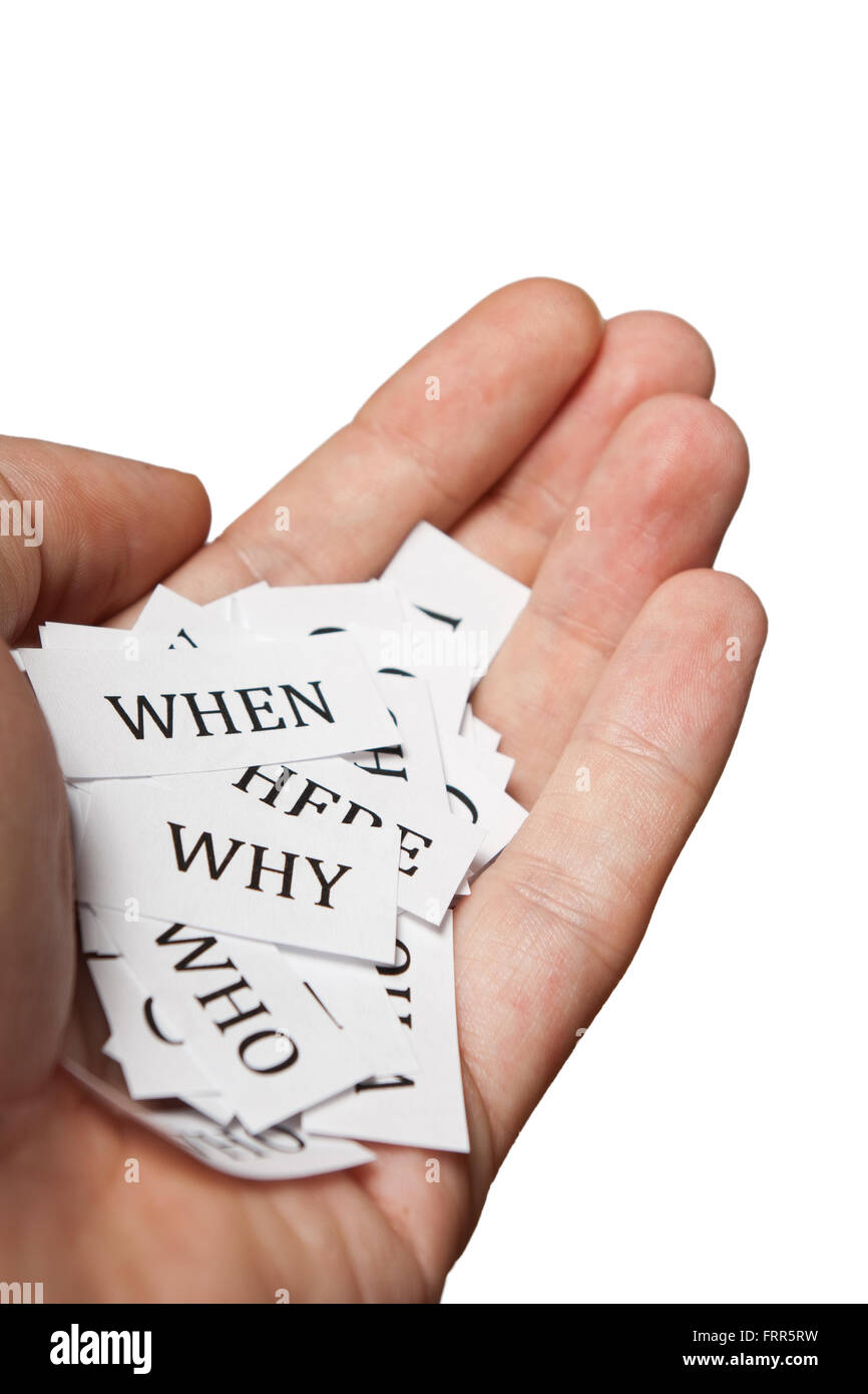 Who what when where why printouts held in hand Stock Photo - Alamy