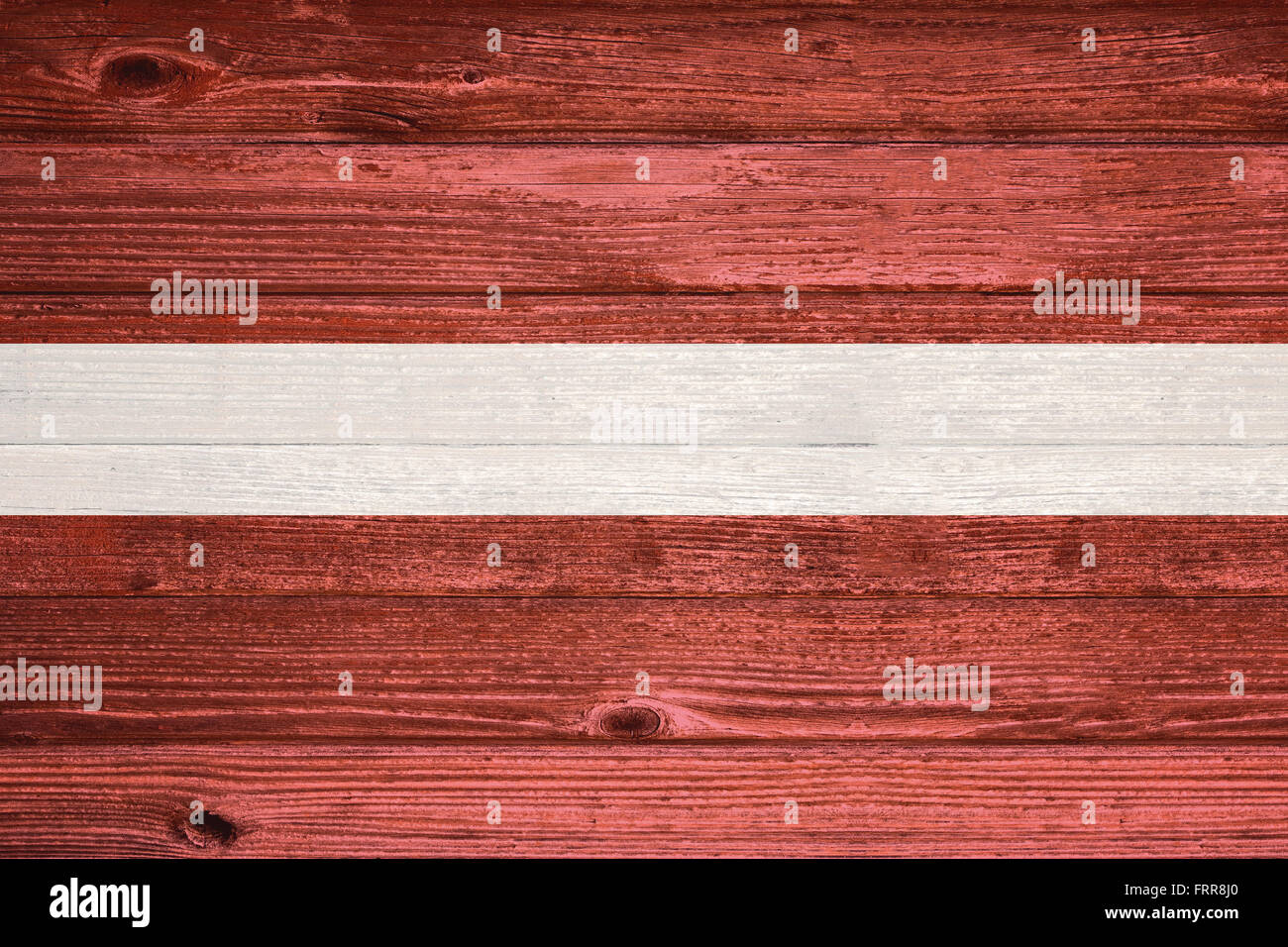 Latvia Flag painted on old wood plank background Stock Photo - Alamy