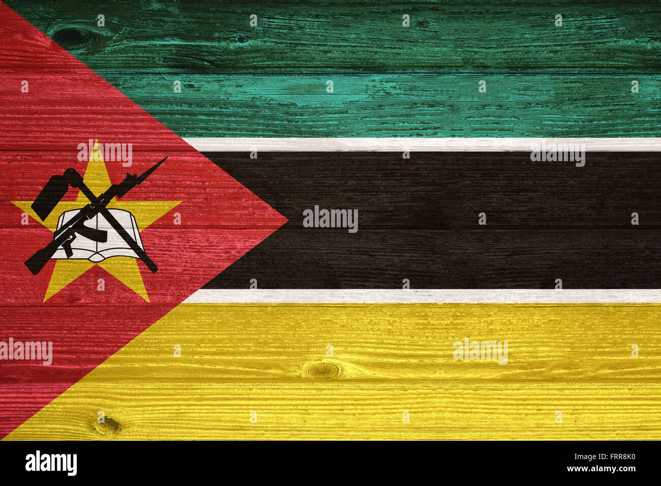 Mozambique Flag painted on old wood plank background Stock Photo