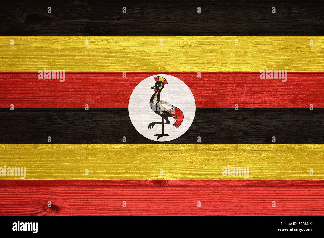 Uganda Flag painted on old wood plank background Stock Photo - Alamy