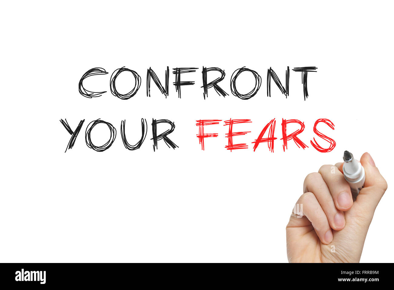 Hand writing confront your fears on a white board Stock Photo