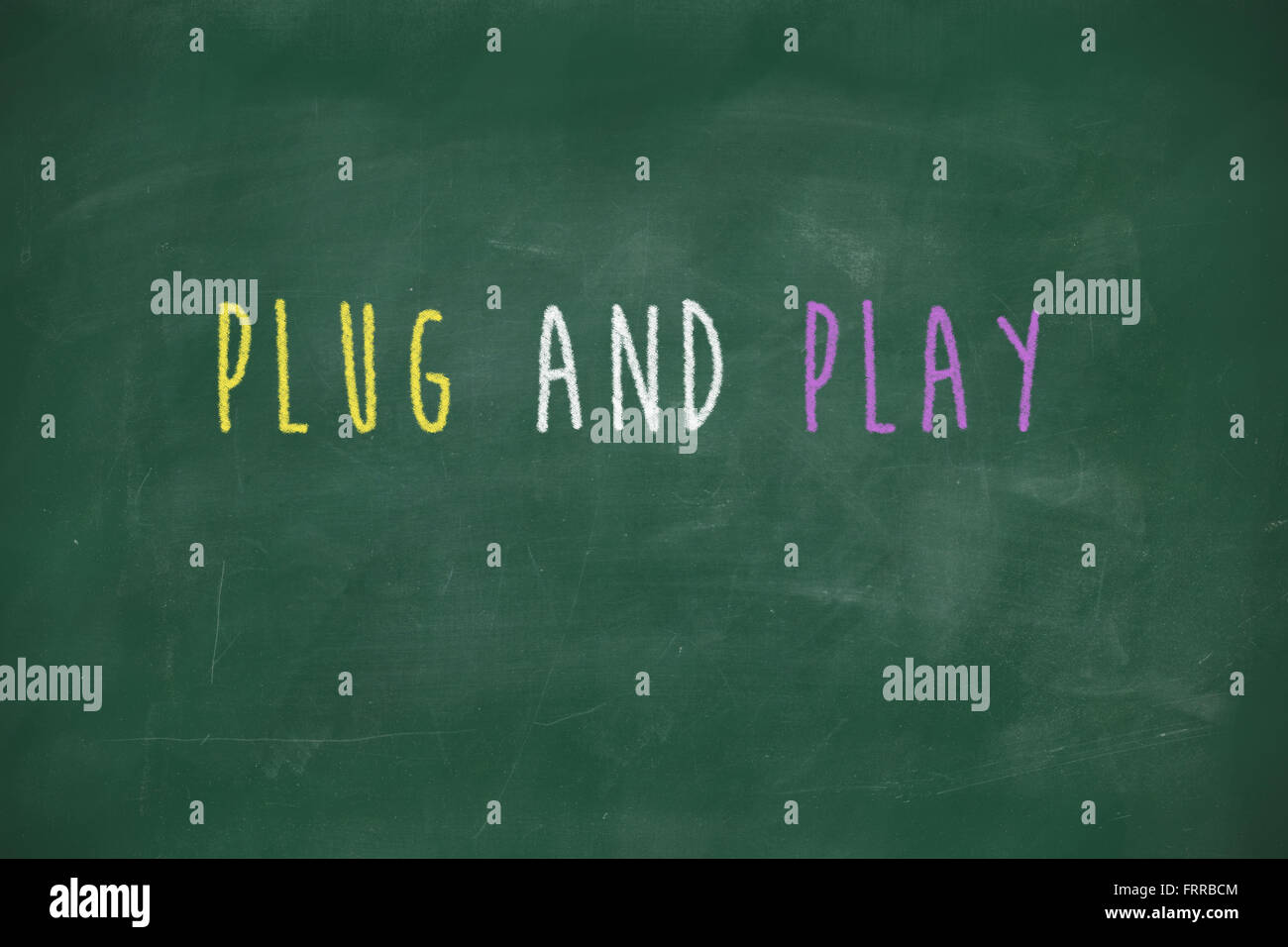 Plug and play handwritten on school blackboard Stock Photo