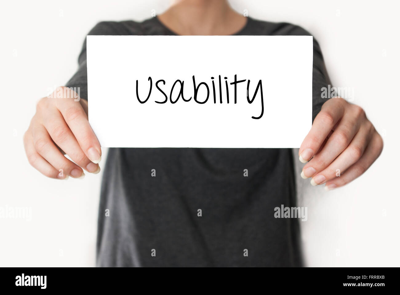 Usability. Female in black shirt showing or holding a card Stock Photo