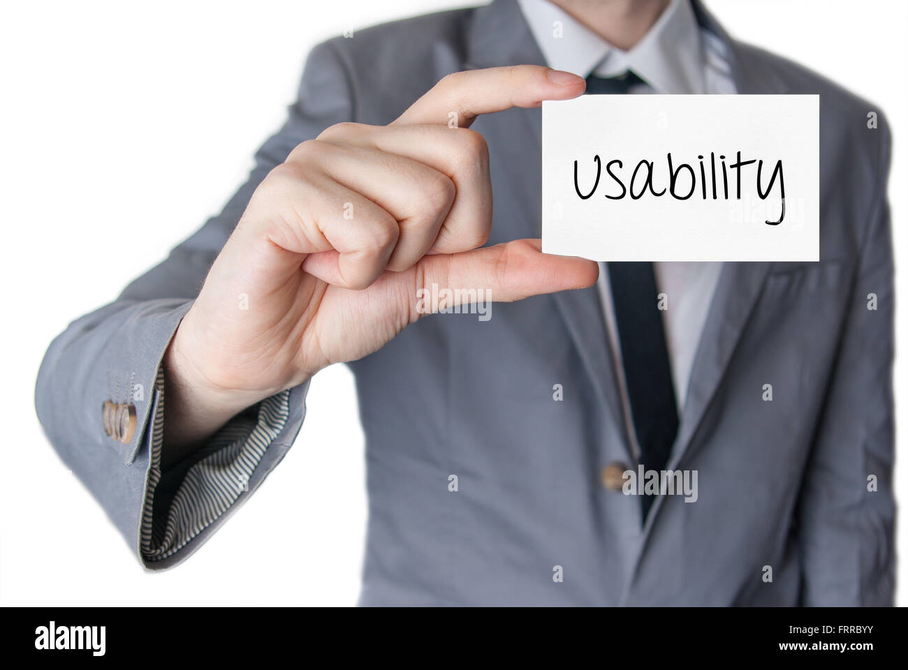 Usability. Businessman in suit with a black tie showing or holding business card Stock Photo