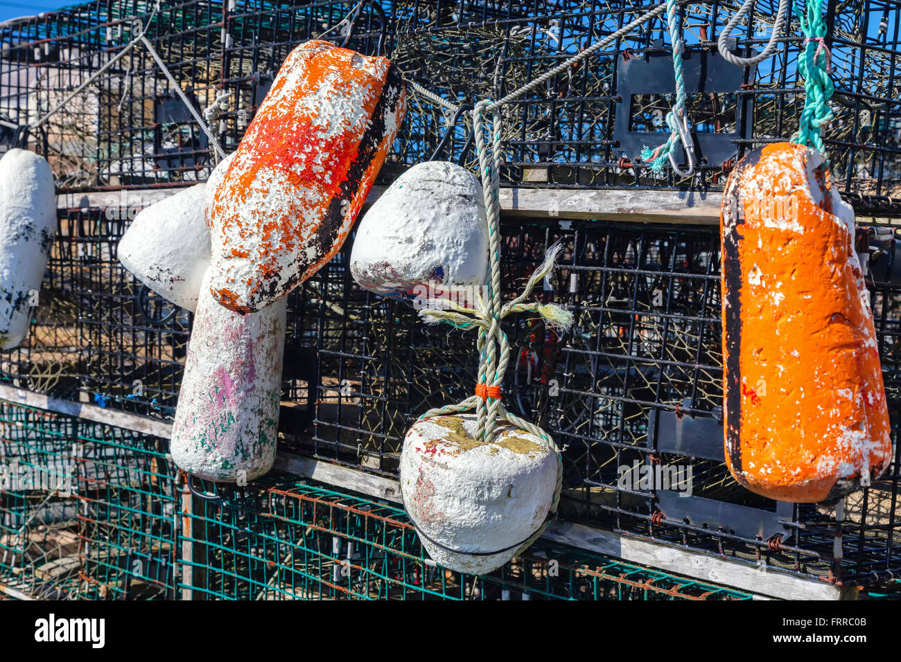 Weathered buoys and traditional lobster traps on the wharf. Stock Photo