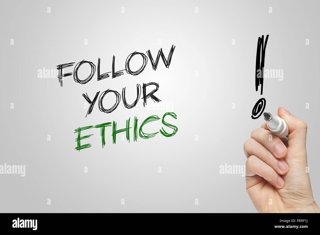Hand writing follow your ethics on grey background Stock Photo