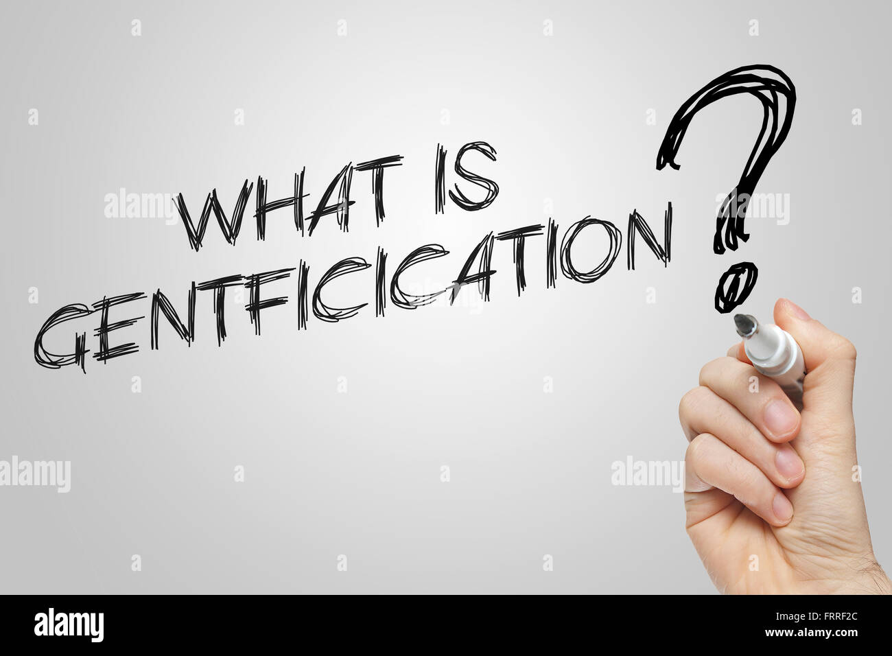 Hand writing what is gentrification on grey background Stock Photo