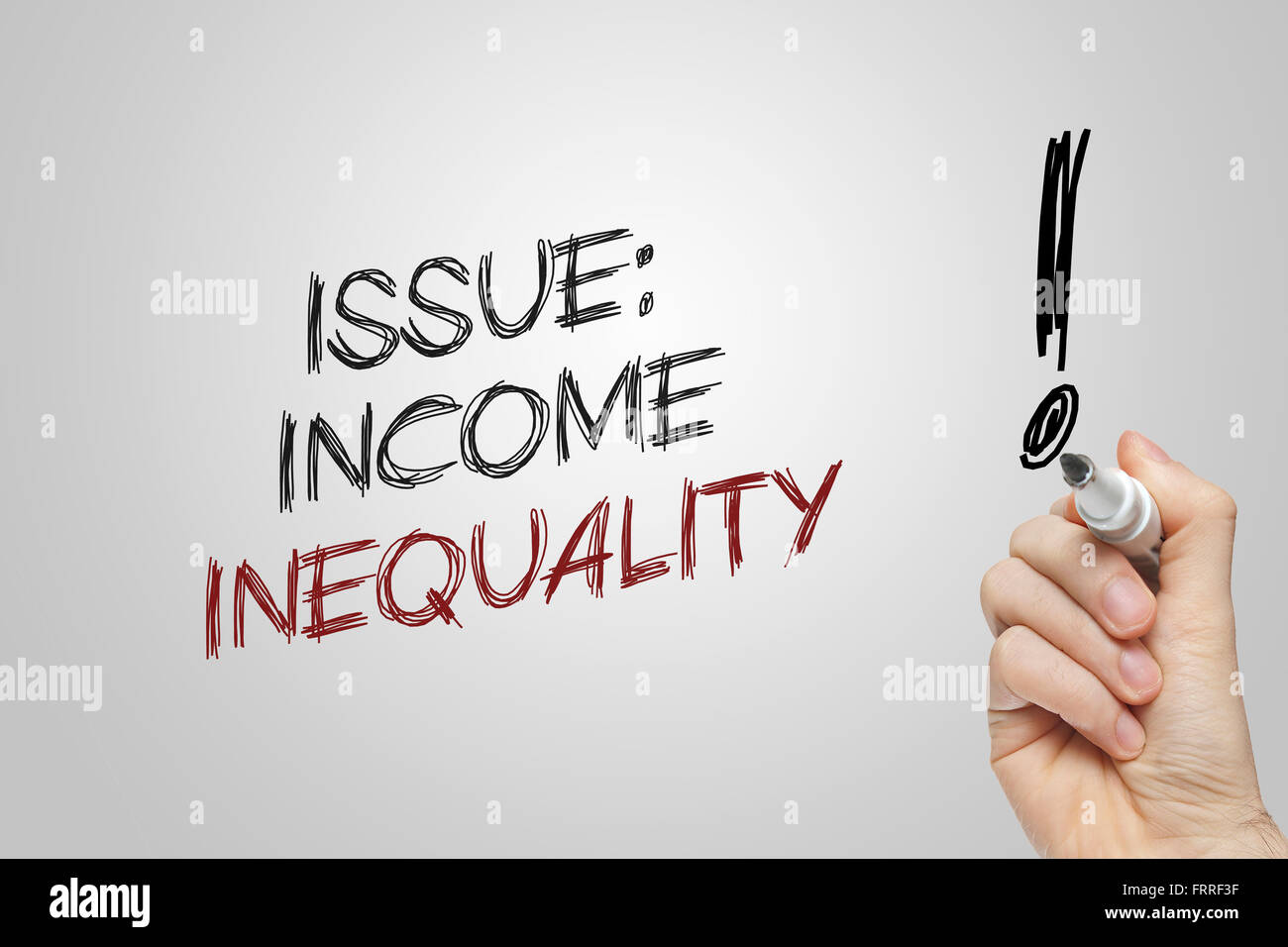 Hand writing issue income inequality on grey background Stock Photo