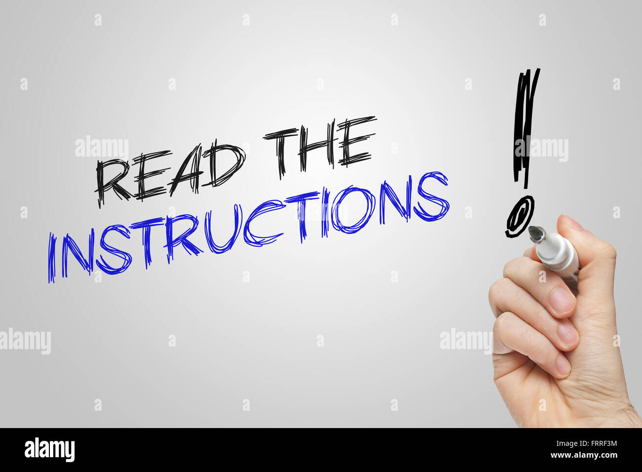 Hand writing read the instructions on grey background Stock Photo - Alamy