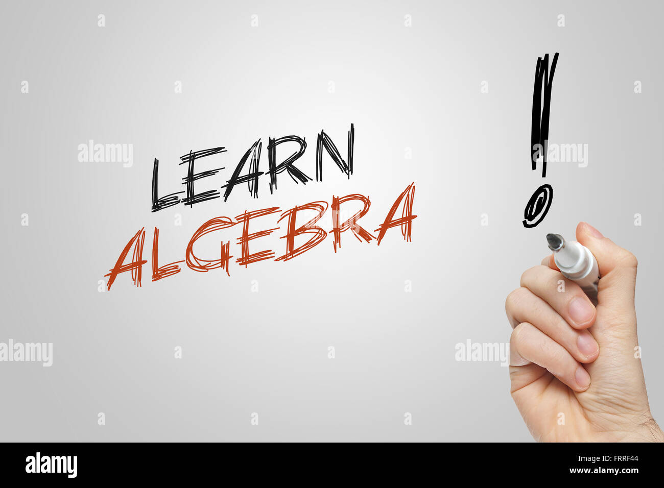 Hand writing learn algebra on grey background Stock Photo