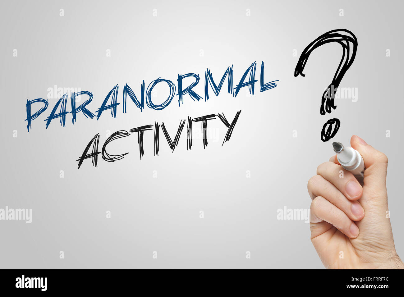 Hand writing paranormal activity on grey background Stock Photo
