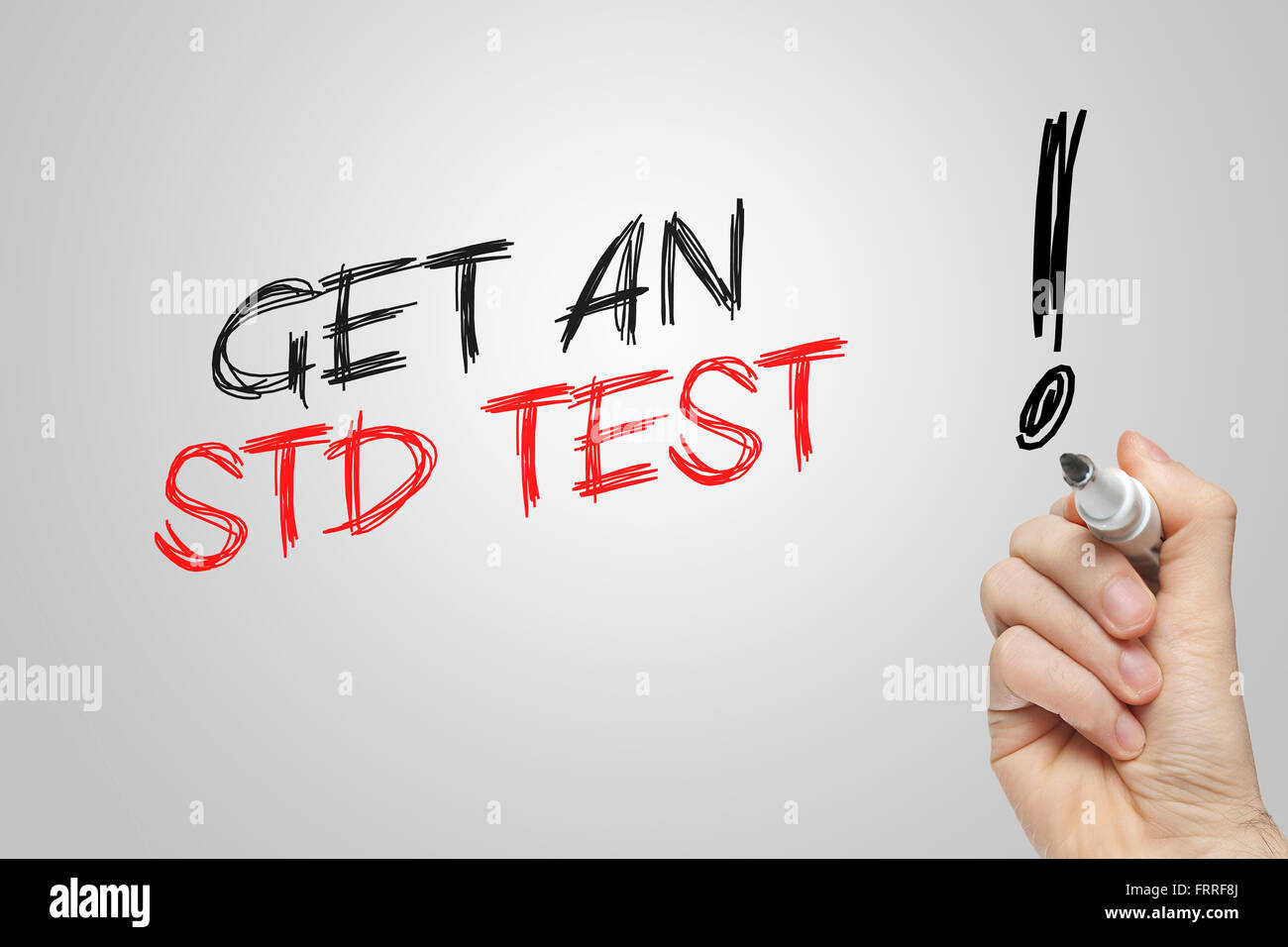 Hand writing get an std test on grey background Stock Photo