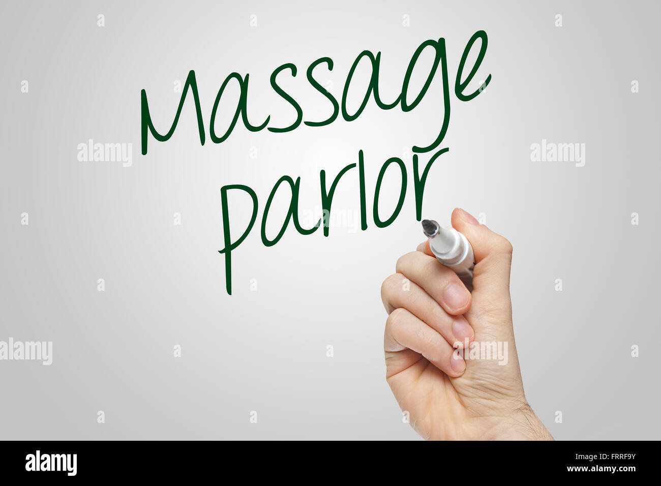 Hand writing massage parlor on grey background Stock Photo Alamy