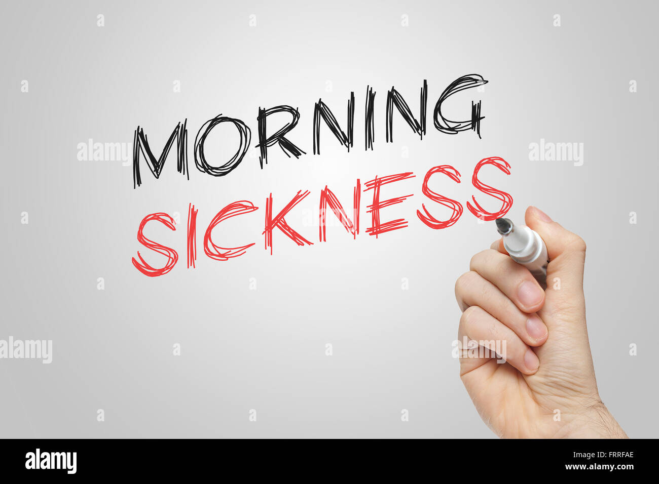 Hand writing morning sickness on grey background Stock Photo