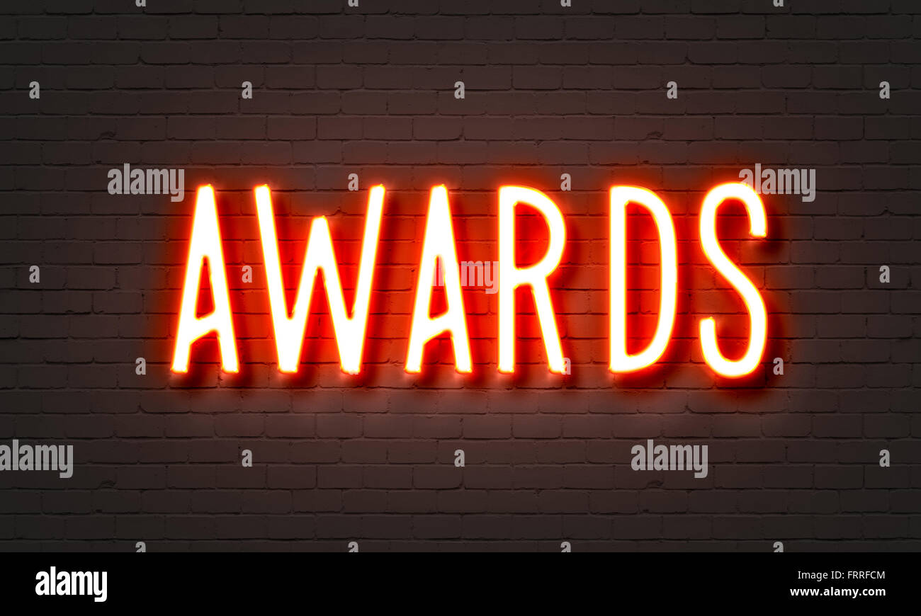 Awards neon sign on brick wall background Stock Photo
