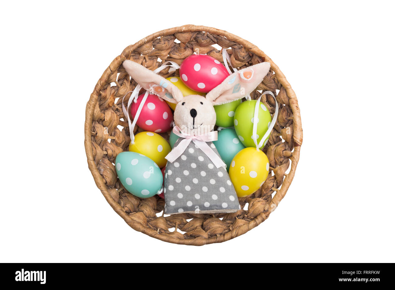 Toy Easter bunny in a wicker basket with dyed eggs Stock Photo - Alamy