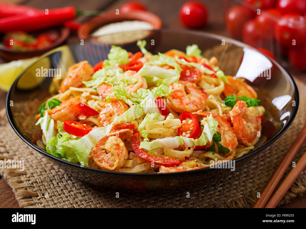 Udon pasta with shrimp, tomatoes and paprika Stock Photo Alamy
