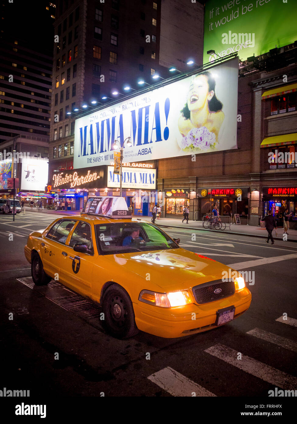 Broadway, New York City, USA Mamma Mia illuminated sign and taxi at
