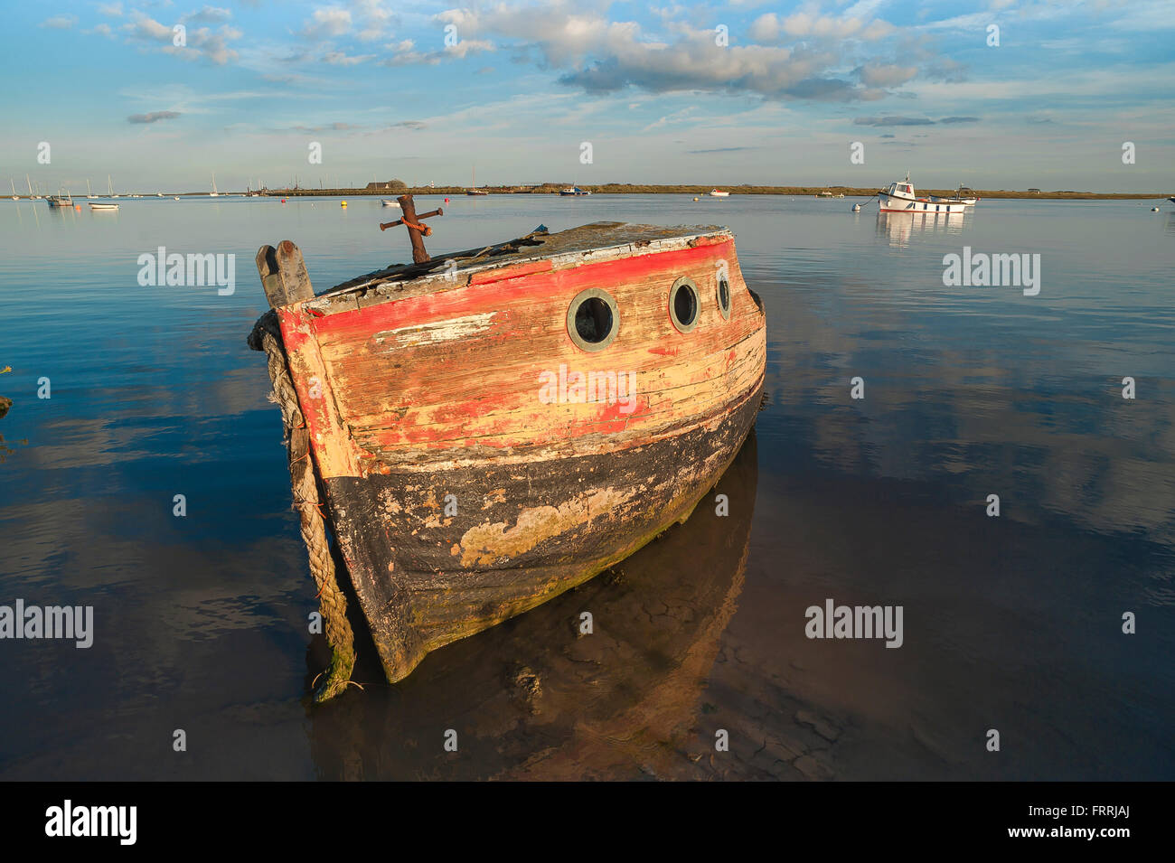 River Alde Suffolk, view at sunset of an abandoned boat left to decay along the river's edge at Orford, Suffolk, England, UK. Stock Photo