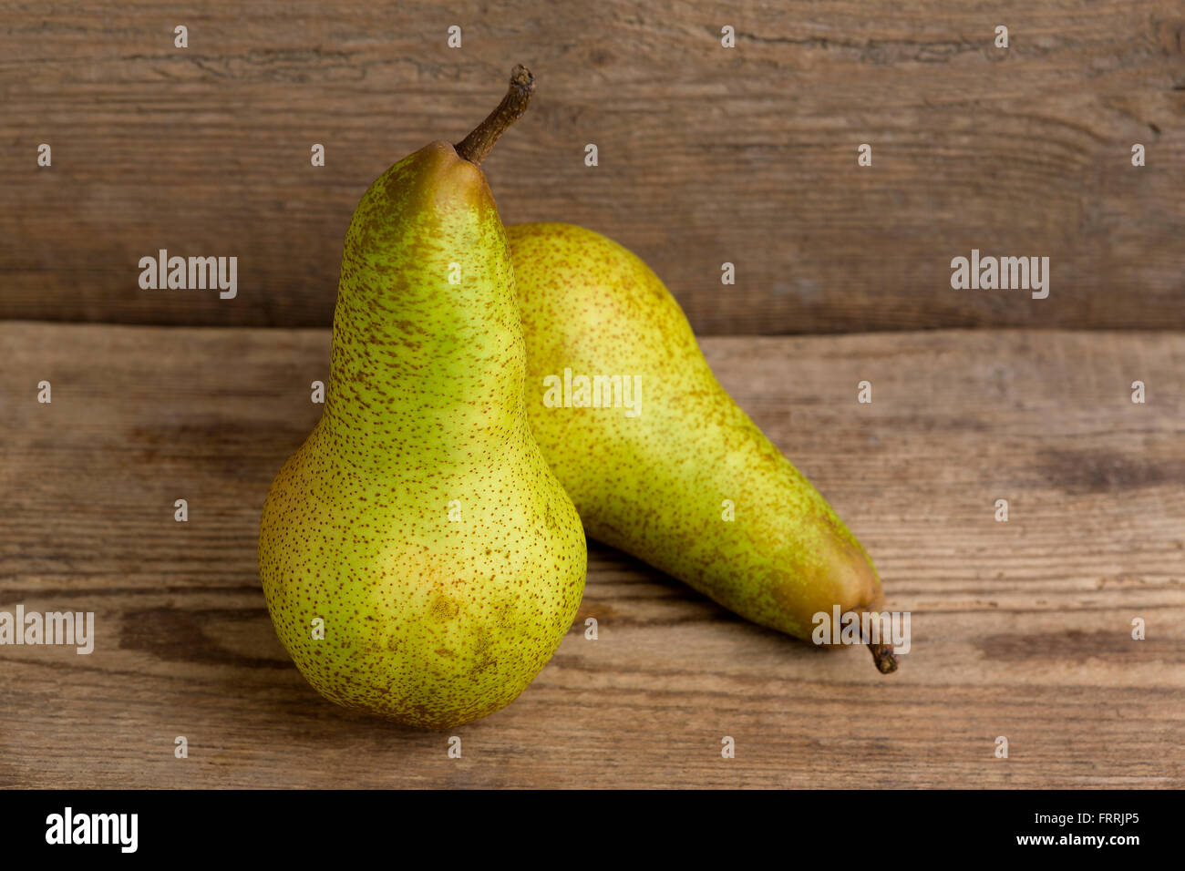 Two pears on wooden background, natural light Stock Photo
