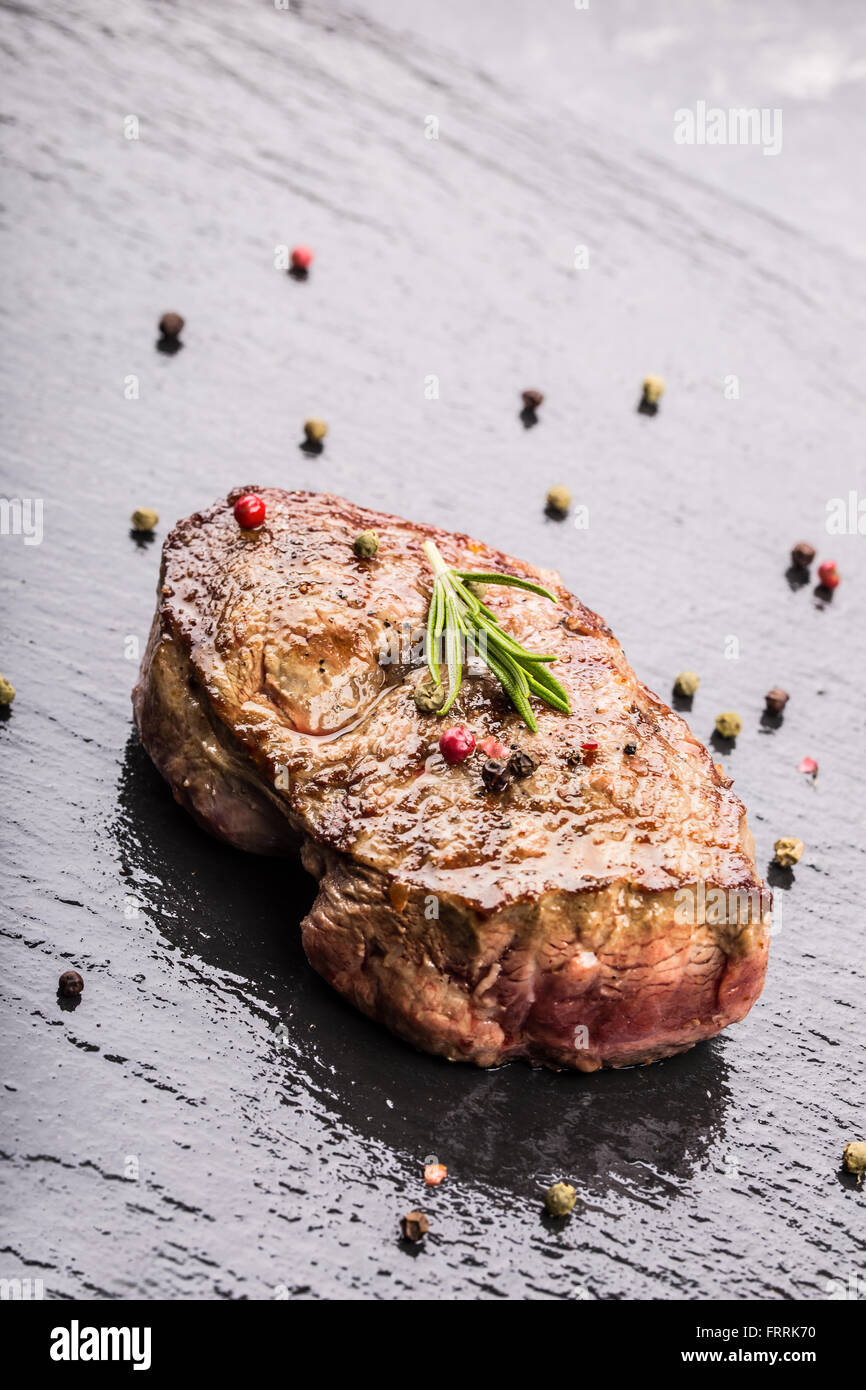 Steak. Grill beef steak. Portions thick beef juicy sirloin steaks on grill teflon pan or granite board. Stock Photo