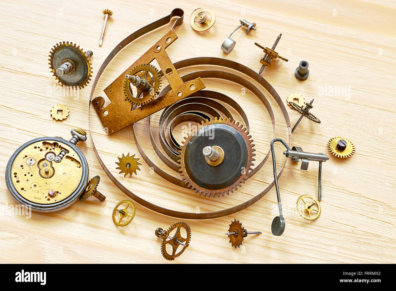 Pile of the old parts of  mechanical clocks on a wooden background Stock Photo