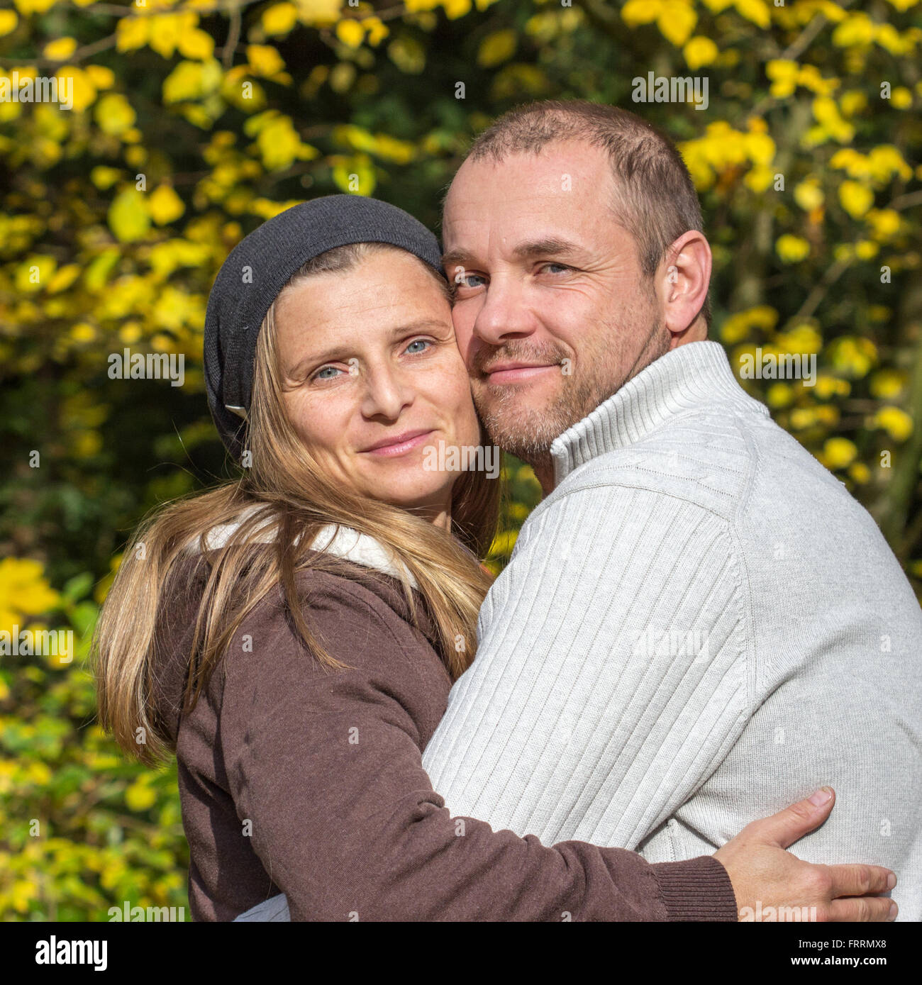 happy couple embracing in park Stock Photo