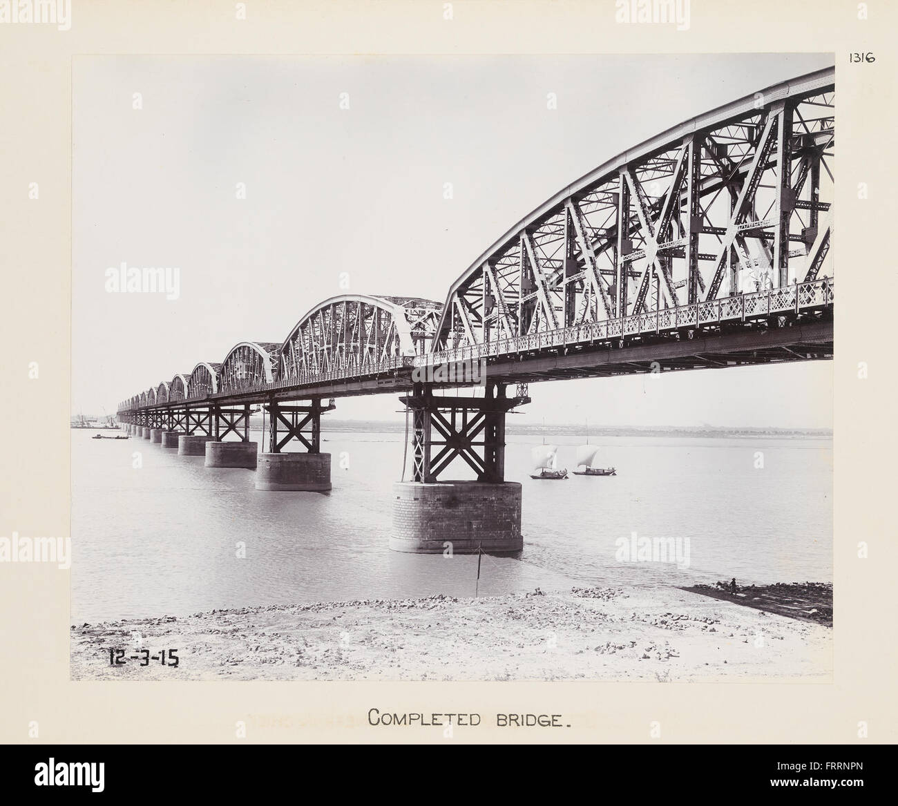 The photograph shows a completed railroad bridge, highlighting the ...