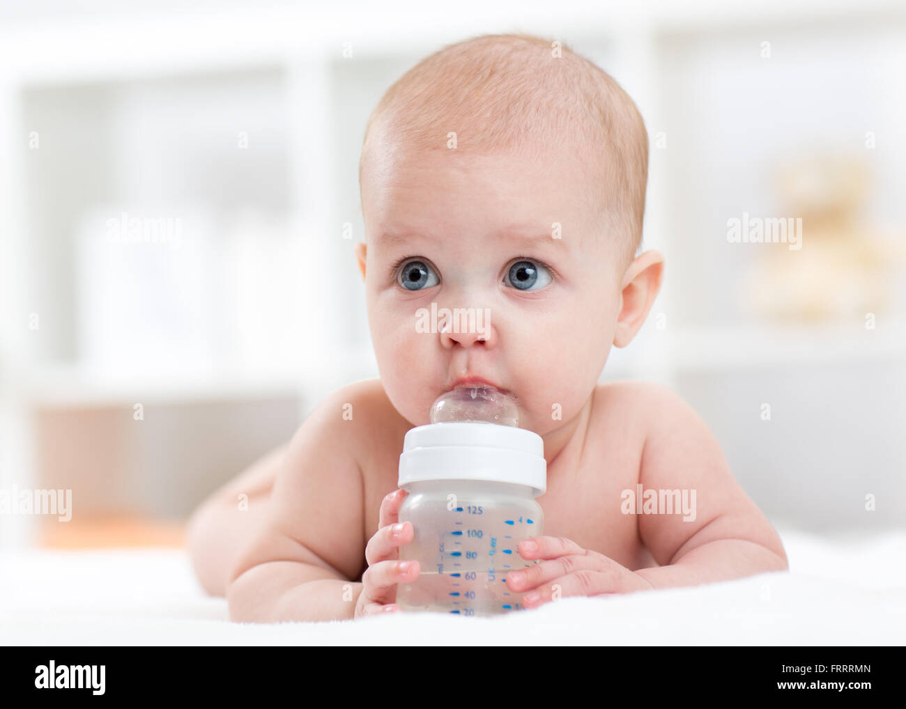 Cute baby drinking water from bottle Stock Photo Alamy