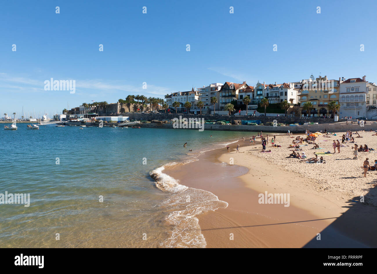 CASCAIS, PORTUGAL - JUNE 13, 2013: People sunbathing on the Praia da Rainha beach on June 13, 2013 in Cascais, Portugal Stock Photo