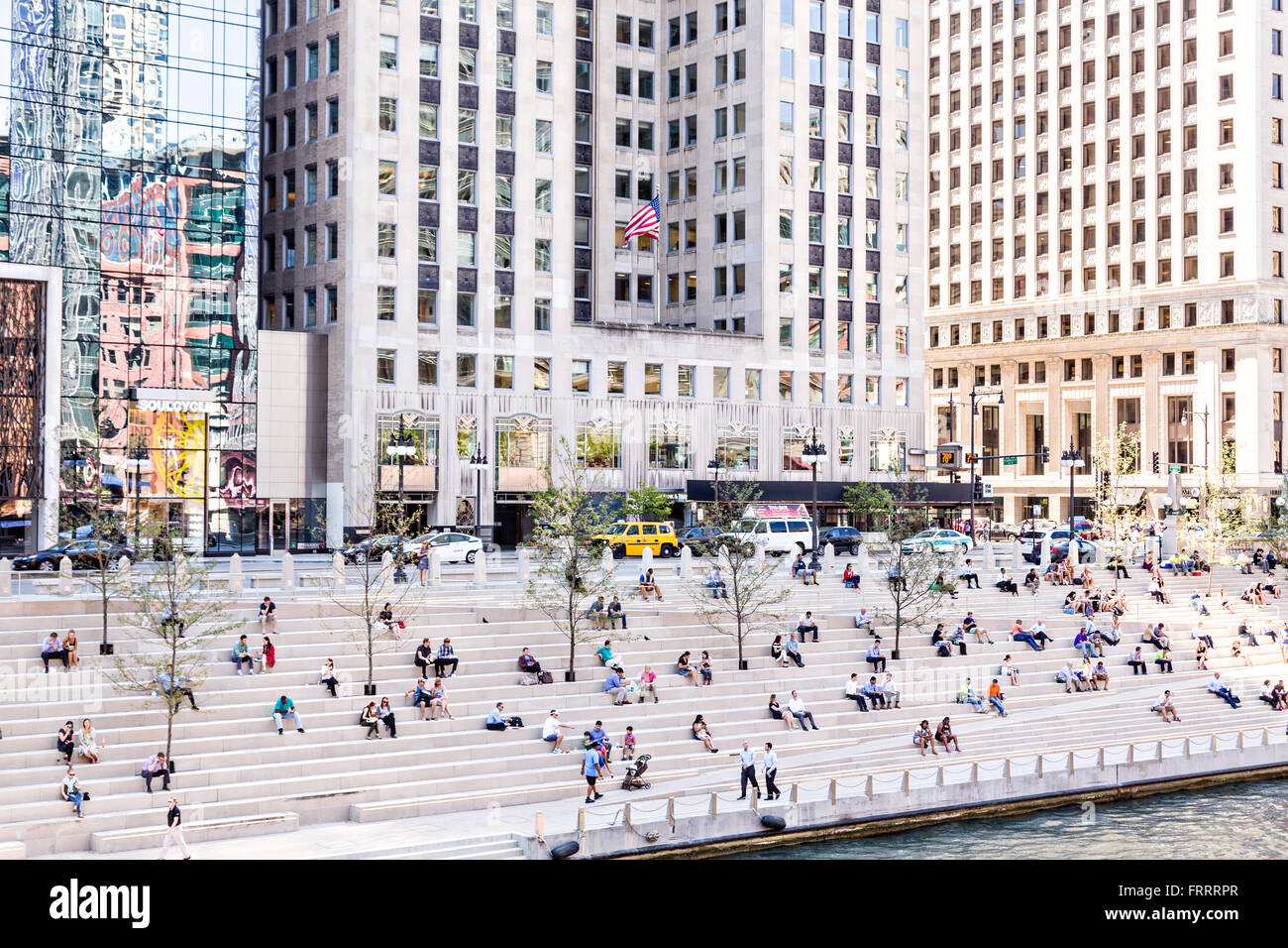 People relax along the Riverwalk near Wacker Drive and North Clark Street on a summers day in Chicago, Illinois, USA Stock Photo