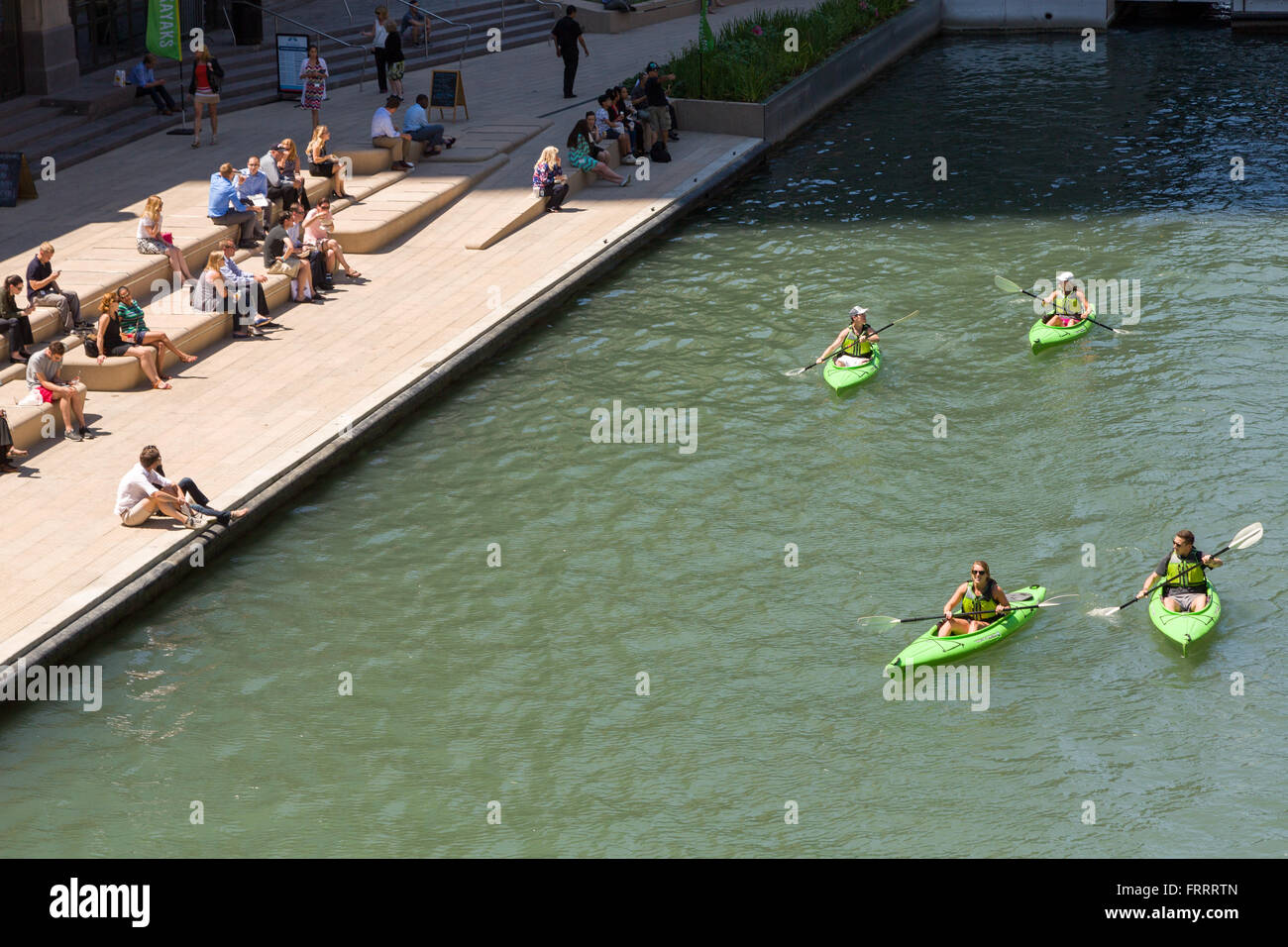 Kayakers on the Chicago River stop at the Riverwalk on a summers day in Chicago, Illinois, USA Stock Photo