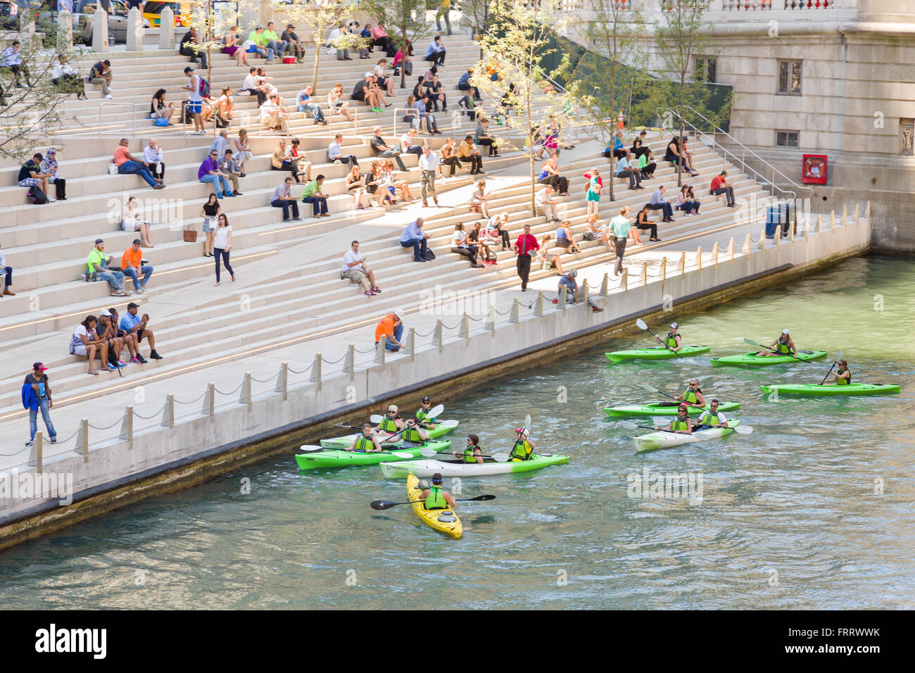 Kayakers on the Chicago River stop at the Riverwalk spot called the River Theater on a summers day in Chicago, Illinois, USA Stock Photo