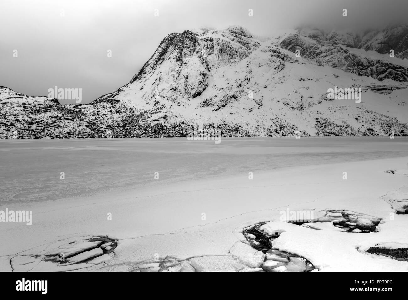 Storvatnet Lake in front of the landscape of the Lofoten mountains on the island Flakstadoy in the winter. Stock Photo