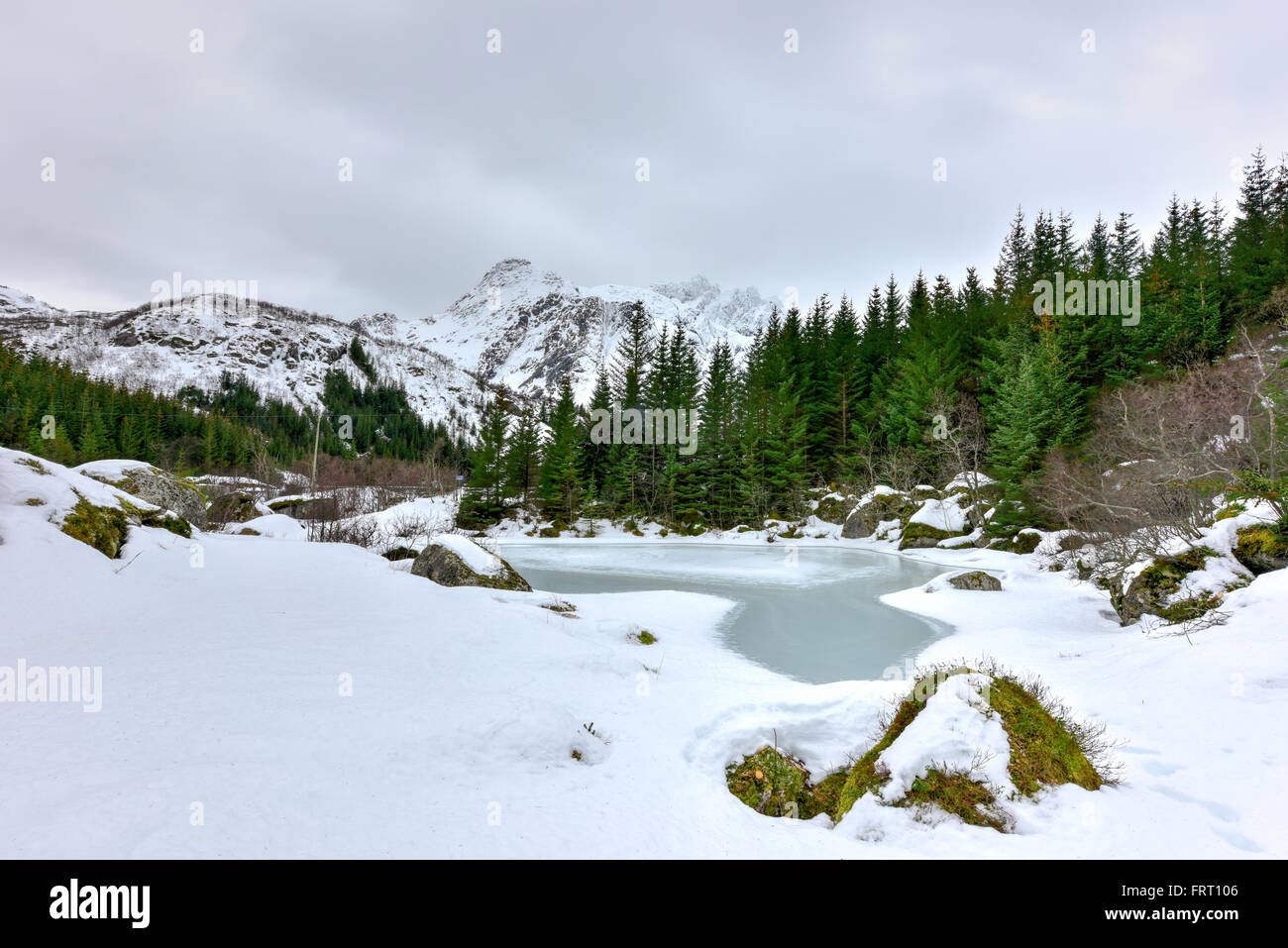 Storvatnet Lake in front of the landscape of the Lofoten mountains on the island Flakstadoy in the winter. Stock Photo