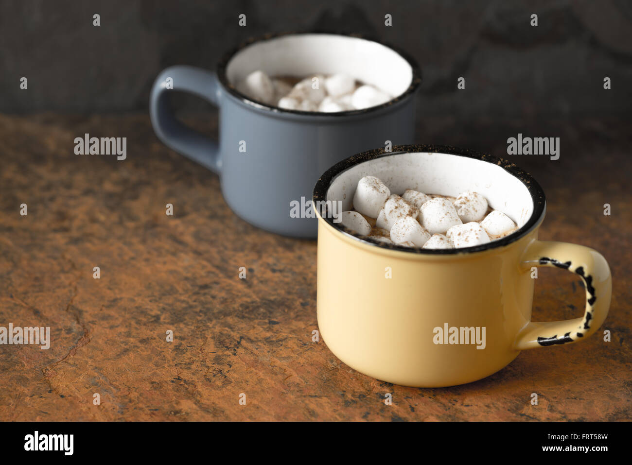 Cups of cocoa with marshmallows on the stone table Stock Photo