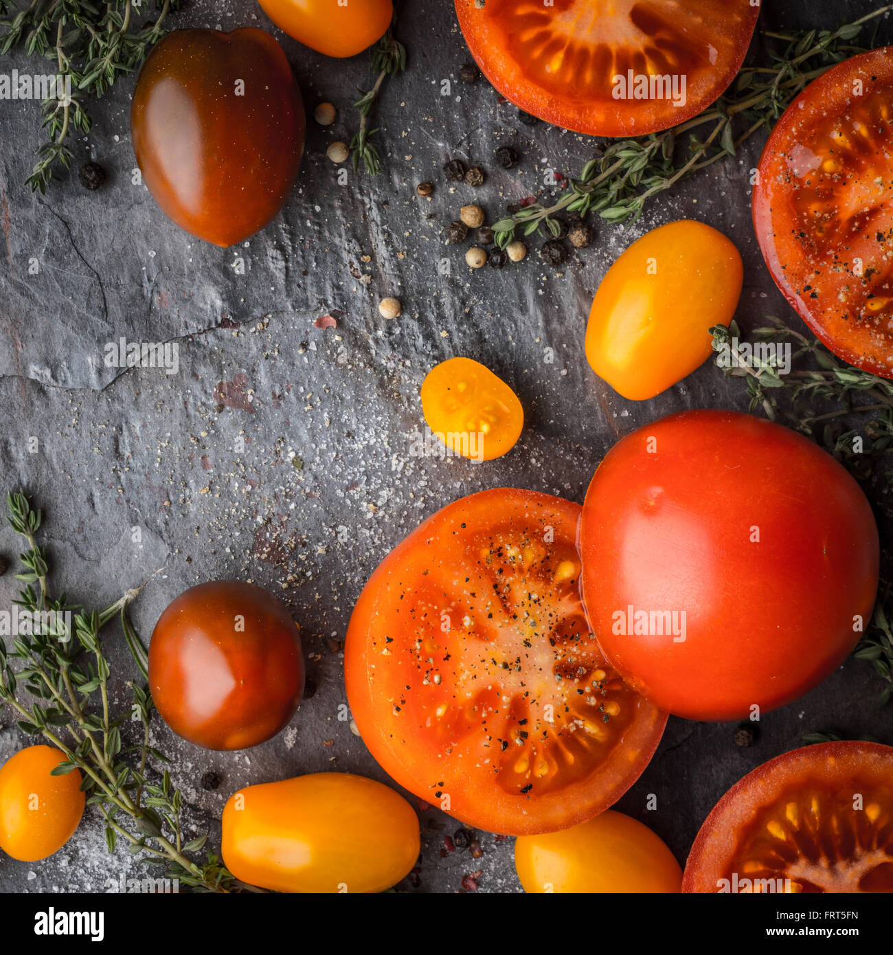Tomatoes mix with herbs on the stone table square Stock Photo Alamy