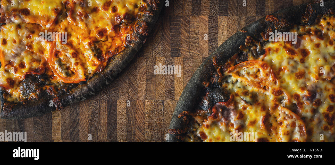 Dough black pizza on the wooden table wide screen Stock Photo