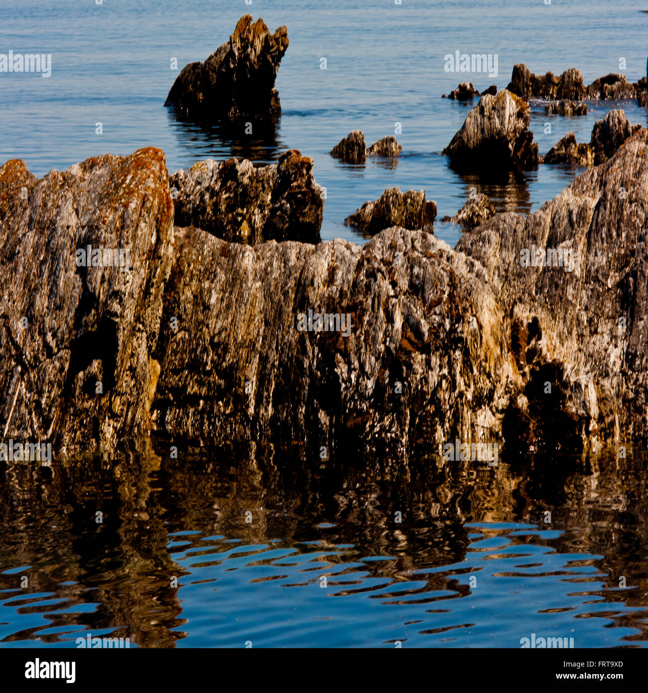 See Rocks Through Water From the sea, rocks penetrating the water waters surface Stock Photo ...