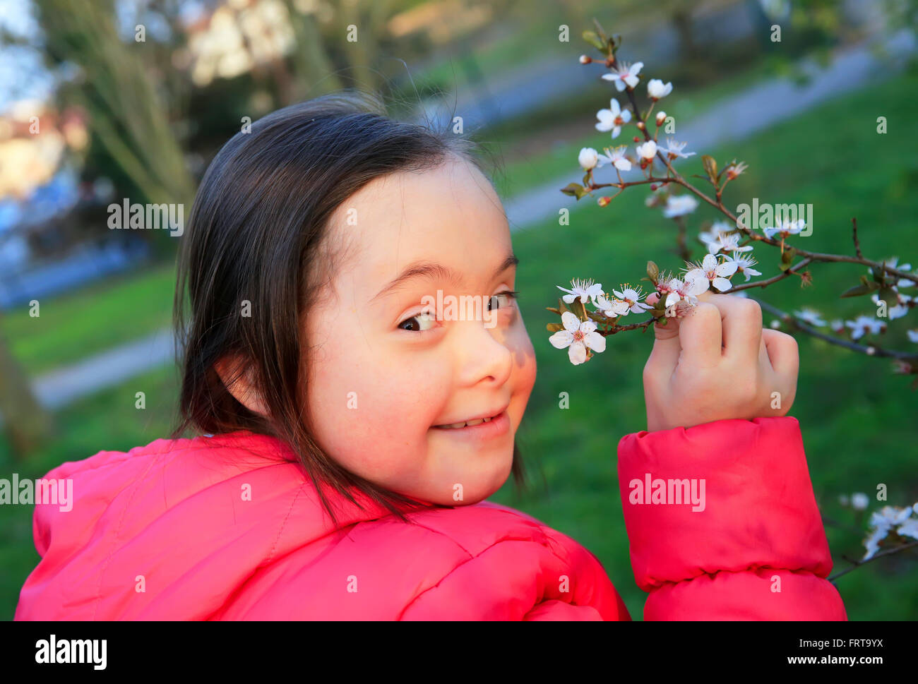 Little girl enjoy with the spring flowers branch Stock Photo